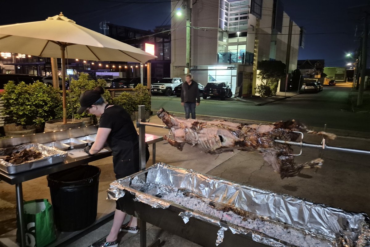 Brisbane Spit Roast Hire team carving meat at an evening event